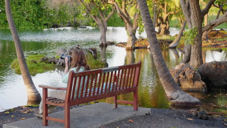 woman photographer at mauna lani fish ponds, hawaii