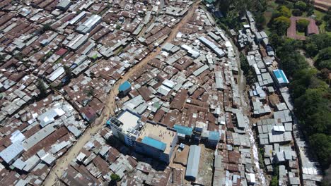 aerial view over people playing on a rooftop in kibera, largest slum in africa