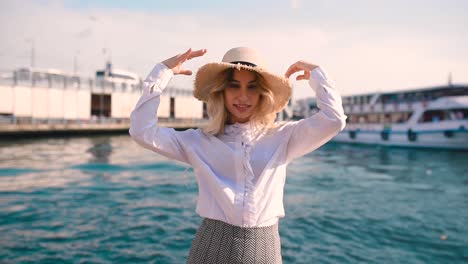 slow motion:beautiful girl poses near bosphorus with view of galata bridge and istanbul