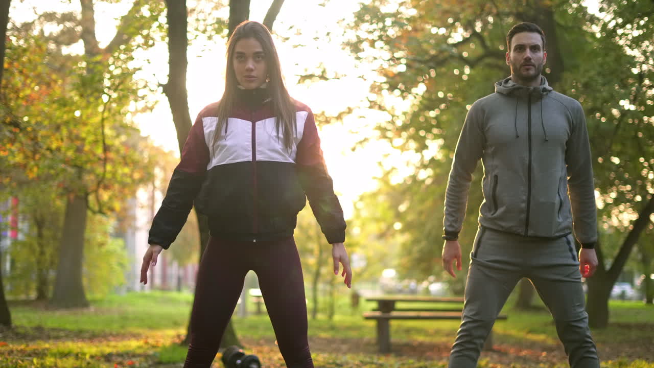 Couple exercising outdoors in a park