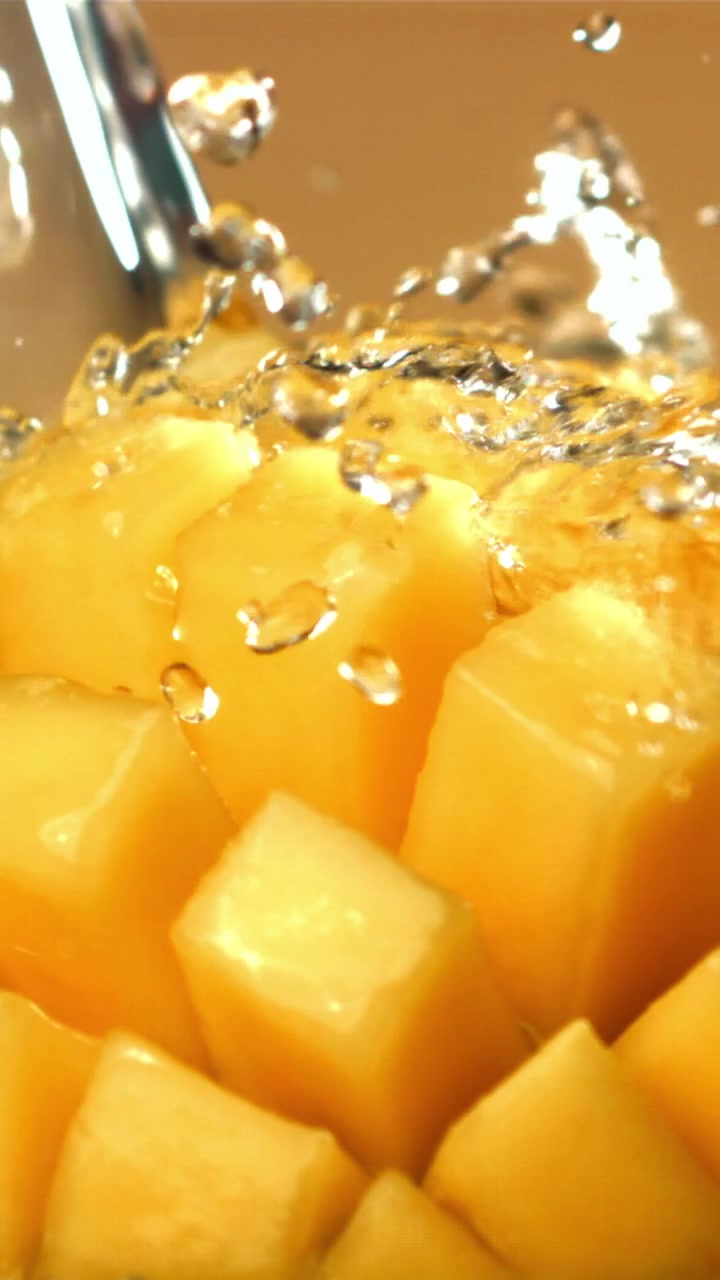 Schizzi d'acqua rinfrescante su mango a cubetti