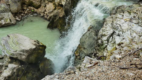 Top-down-shot-of-Waterfall-flowing-into-volcanic-pool-at-Wai-o-tapu-geothermal-area,NZ