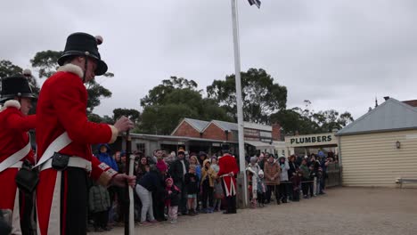 soldier demonstrating gun loading to a crowd