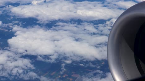 góndola del motor visible frente a una capa de nubes rotas