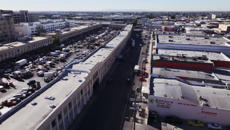 aerial view of an industrial area with vehicle storage lot and commercial buildings