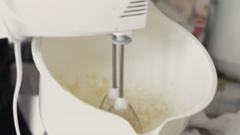 a video of mixing pancakes with a mixer up close