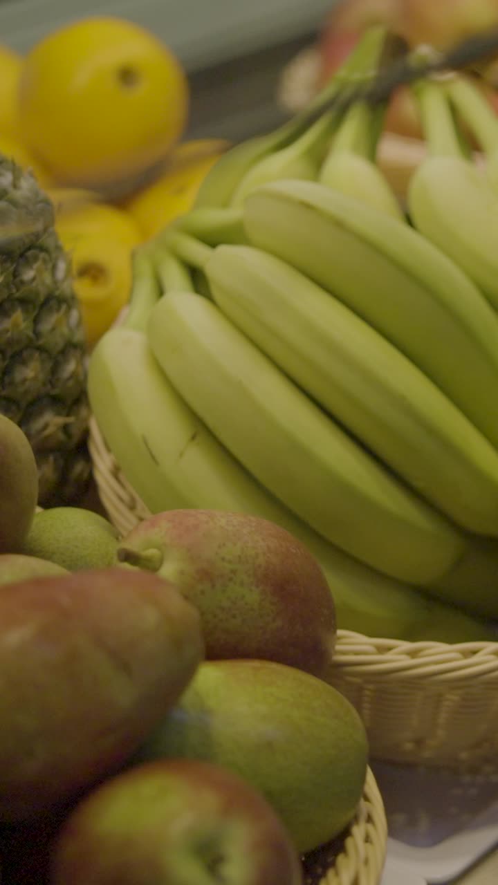 Close-up of fresh bananas and apples at a fruit market, bright and vibrant