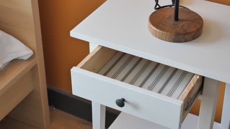 empty white nightstand drawer with lamp