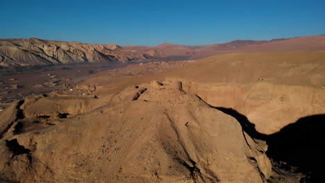 low fly over scenic mountains at red city of bamyan on sunny day in afghanistan