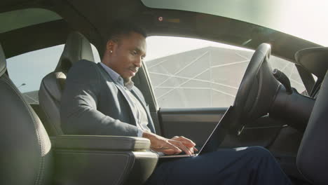 businessman working in an electric car