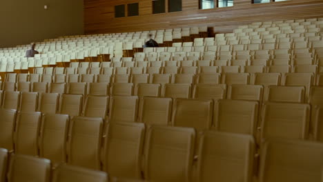 large empty auditorium with a few distant people