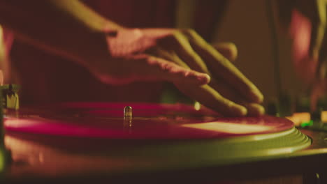 dj mixing vinyl records at nightclub