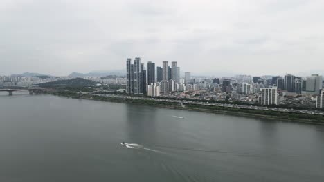 Aerial-flyover-Han-River-and-Seoul-city-with-view-of-Seoul-Forest-park,-South-Korea