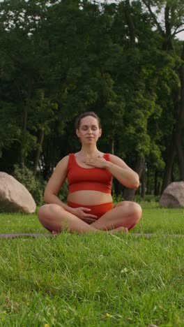 pregnant woman meditating outdoors