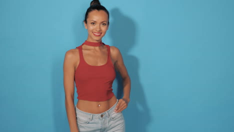 woman in red crop top and light blue jeans