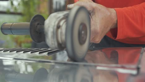 autobody buffing an aluminium bonnet dynamic shot