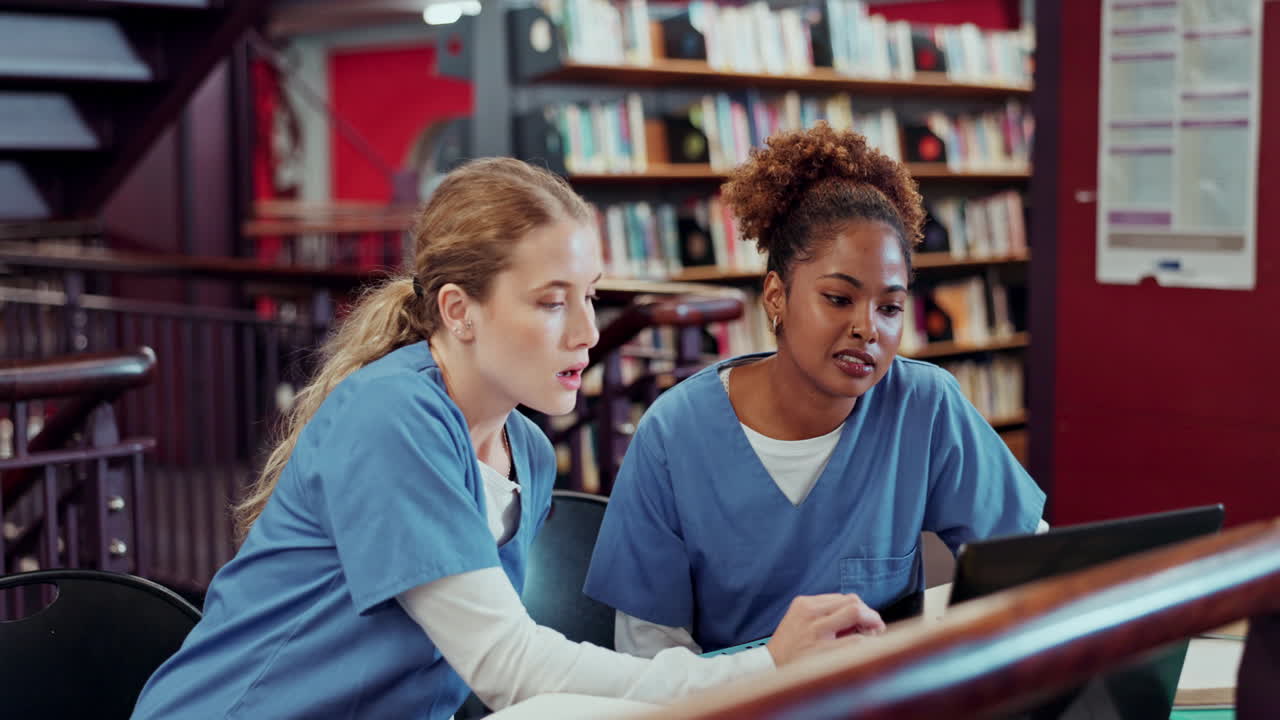 Two students studying in the library