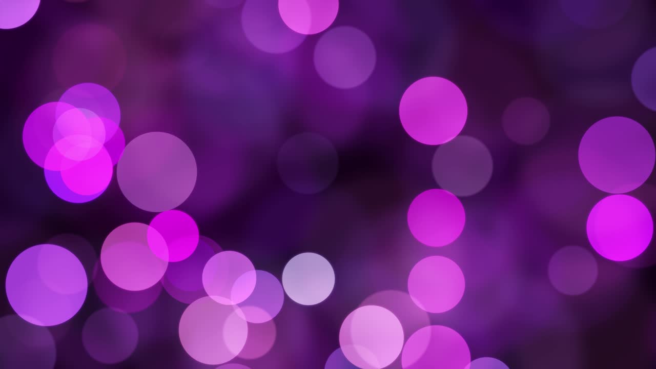 las luces brillantes y brillantes se mueven en un fondo oscuro.