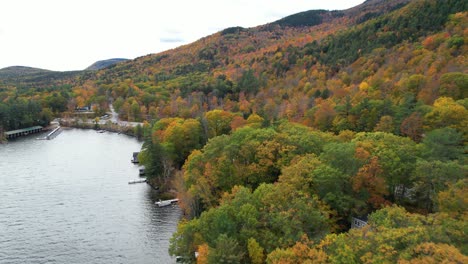 lake sunapee lakefront idyllic colorful forest on autumn and houses near newbury new hampshire usa, drone aerial view