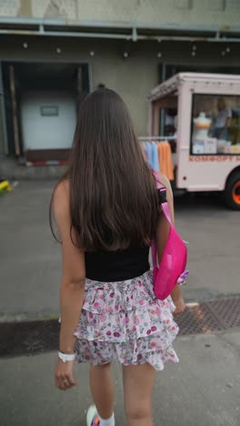 woman walking outdoors near a food truck