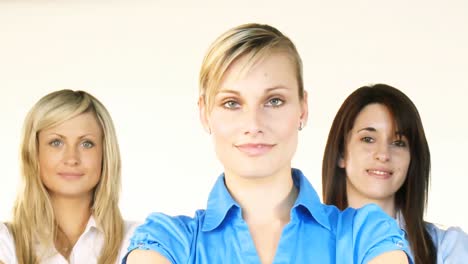 Three-beautiful-businesswomen-smiling-at-the-camera