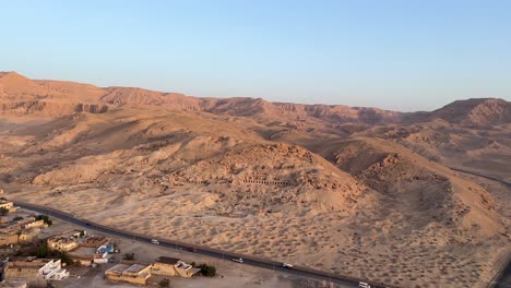 Fly-over-Luxor,-Valley-of-the-Kings-in-Egypt-in-a-Hot-Air-balloon-at-sunrise-overlooking-historical-sites