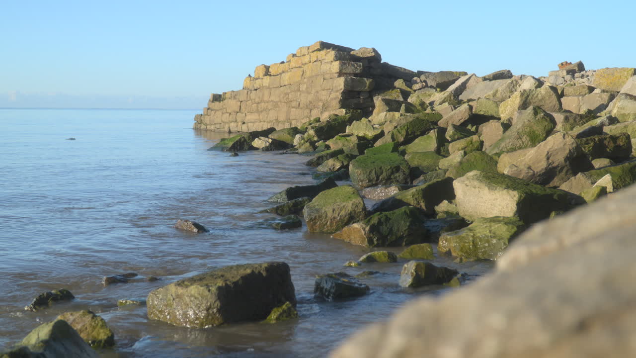 старые руины на береговой линии купаются в раннем утреннем осеннем солнечном свете