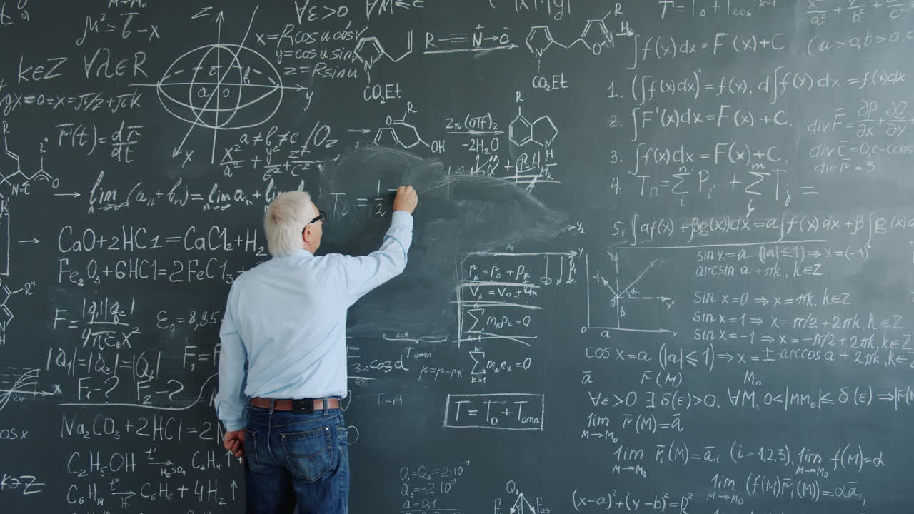 Teacher writing equations on a chalkboard