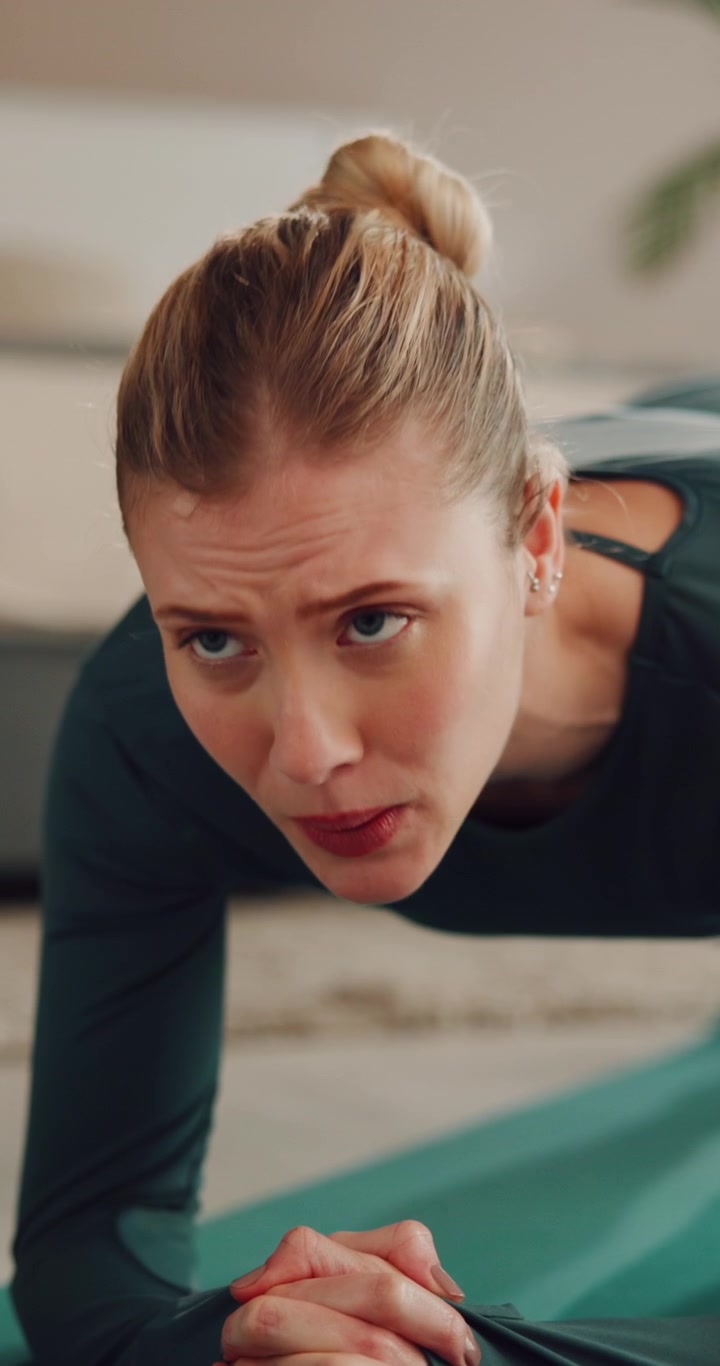 Young Woman Performing Plank Exercise on Yoga Mat at Home