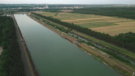 an aerial view of the calm rowing arena, with a double scull on the surface