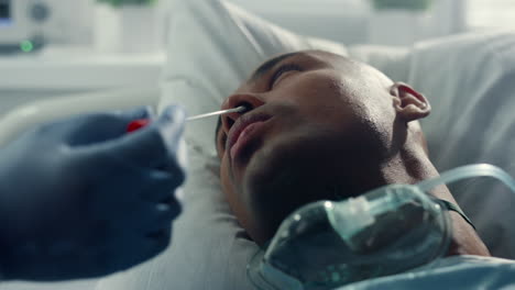 nose swab for covid testing closeup. unknown doctor hands taking medical sample.