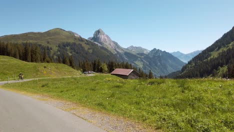 clip of a man biking in the pragelpass, sport in the mountains, sunny day