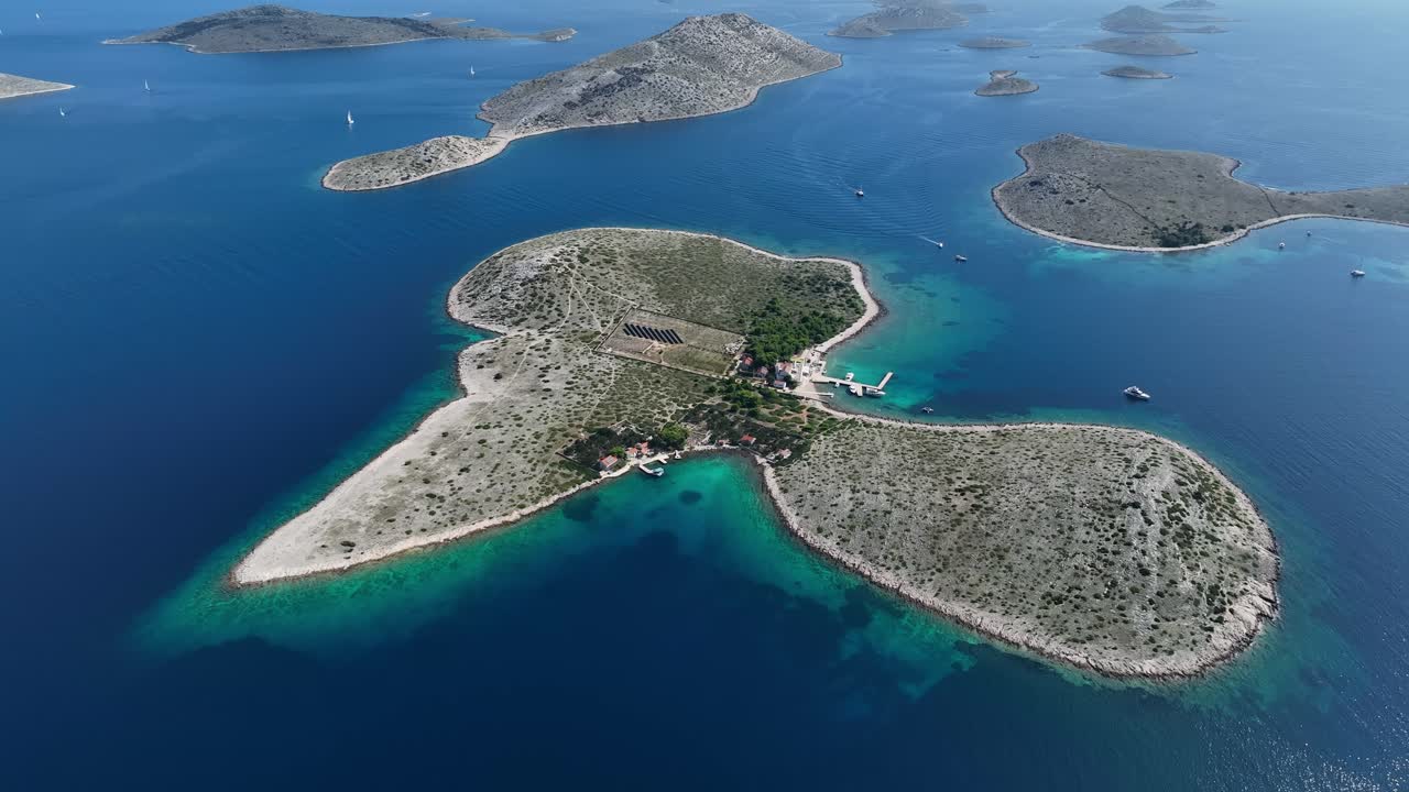 Aerial overview of dock and solar farm in Kornati Islands, turquoise waters and rugged coastlines in the Adriatic Sea Croatia
