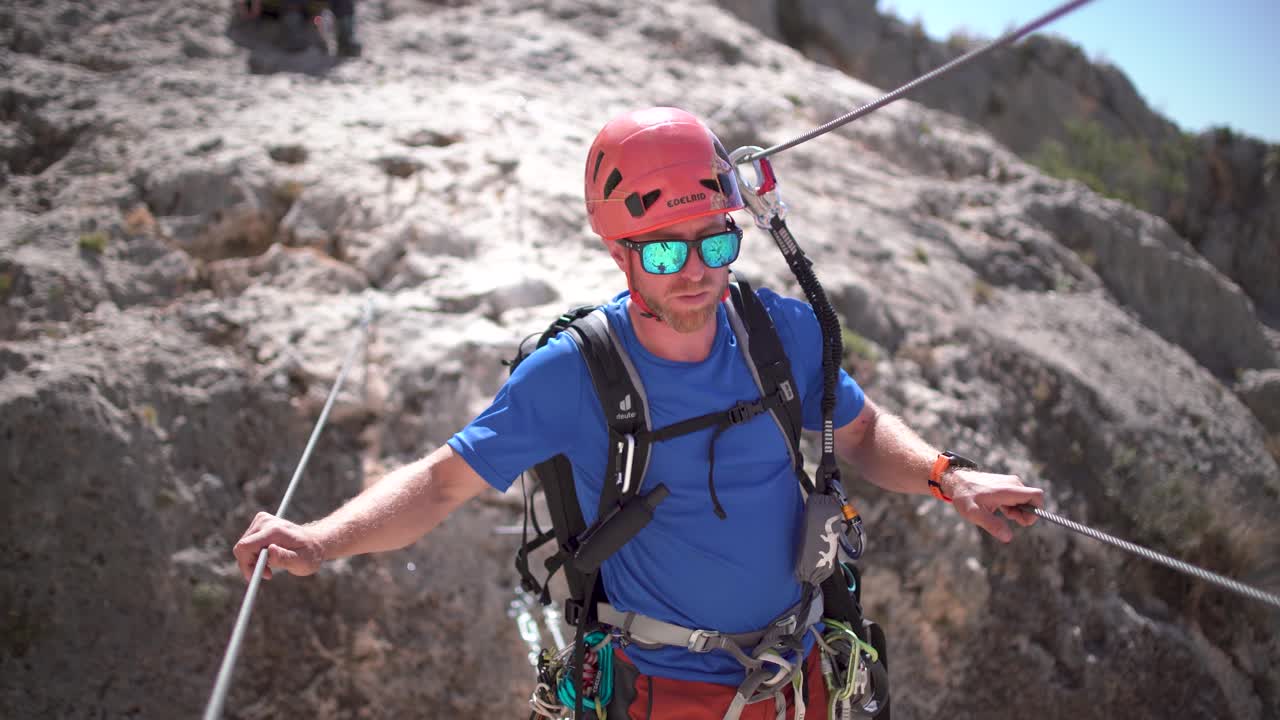 Climbing sports technicians check the condition of a via ferrata Villena, Valencian Community, Spain