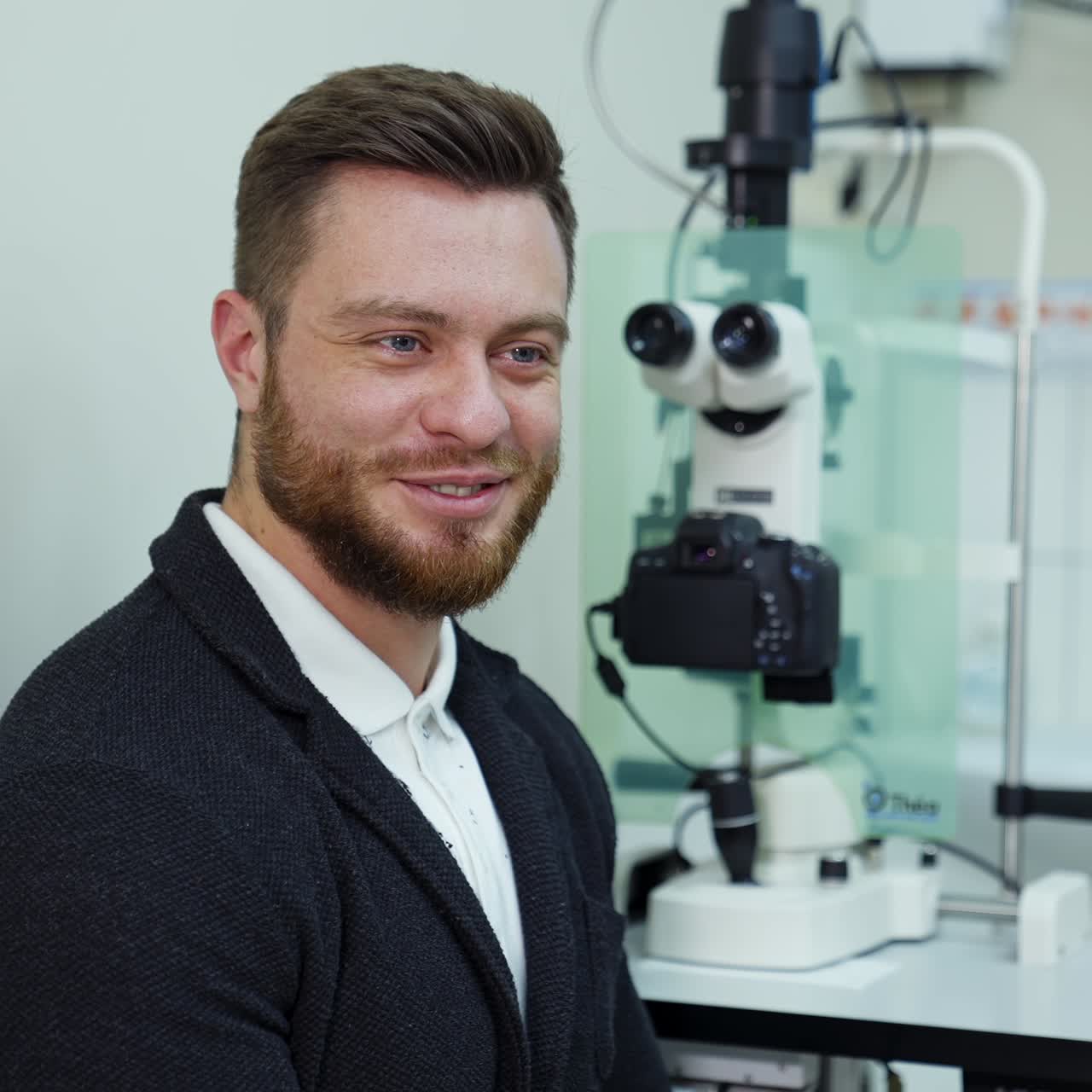 Cheerful young man came to consultation in ophthalmology clinic. Happy man gets happy news about health. Planned visit to clinic