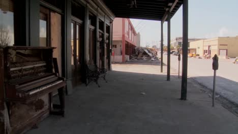 pan across devastated galveston street after hurricane ike and an old piano sitting in front of an abandoned bar