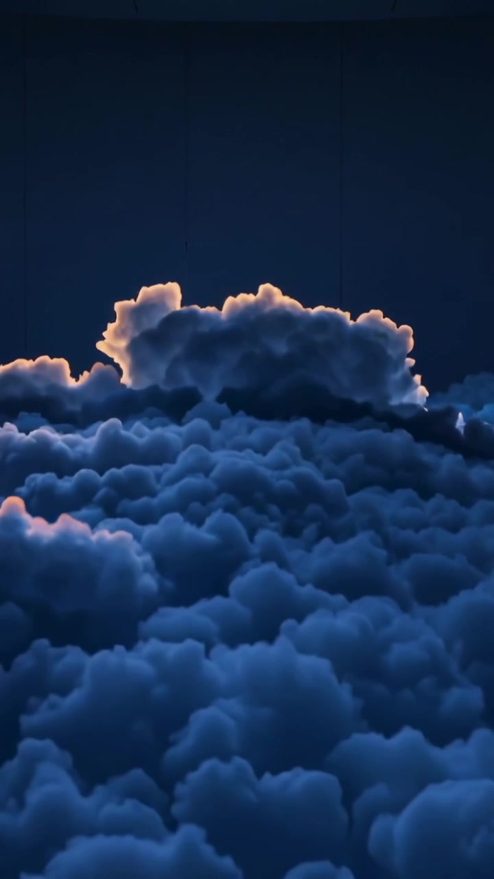 Vertical video: Moving camera revealing cloud ridge nearing horizon at dusk, for warm rim lighting