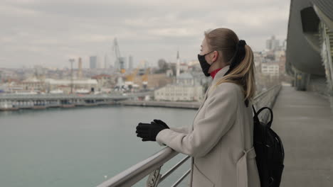 woman looking at the city view with a mask