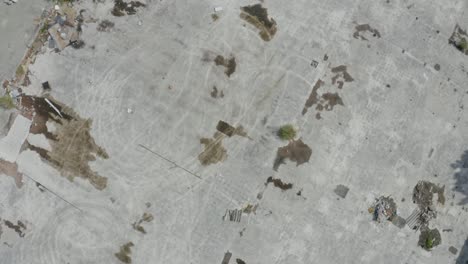 drone footage reveals the aftermath of war with a top-down view of a devastated old factory