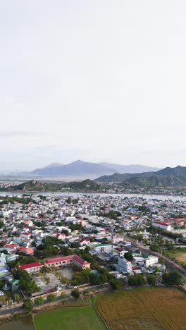 aerial vertical shot dolly pan of city in phan rang–tháp chàm.