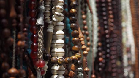 close-up of various prayer beads hanging in a market