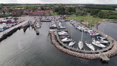 epic drone view from above with a view of the boats in a harbor in denmark - truck shot