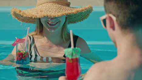 couple enjoying cocktails in a pool