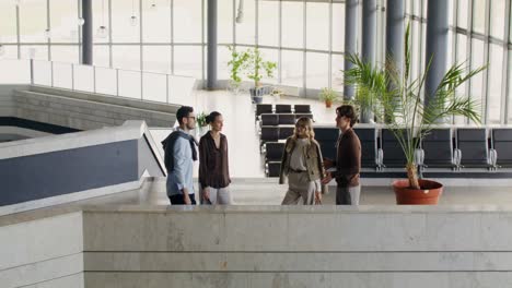 group of people talking in a modern airport lobby