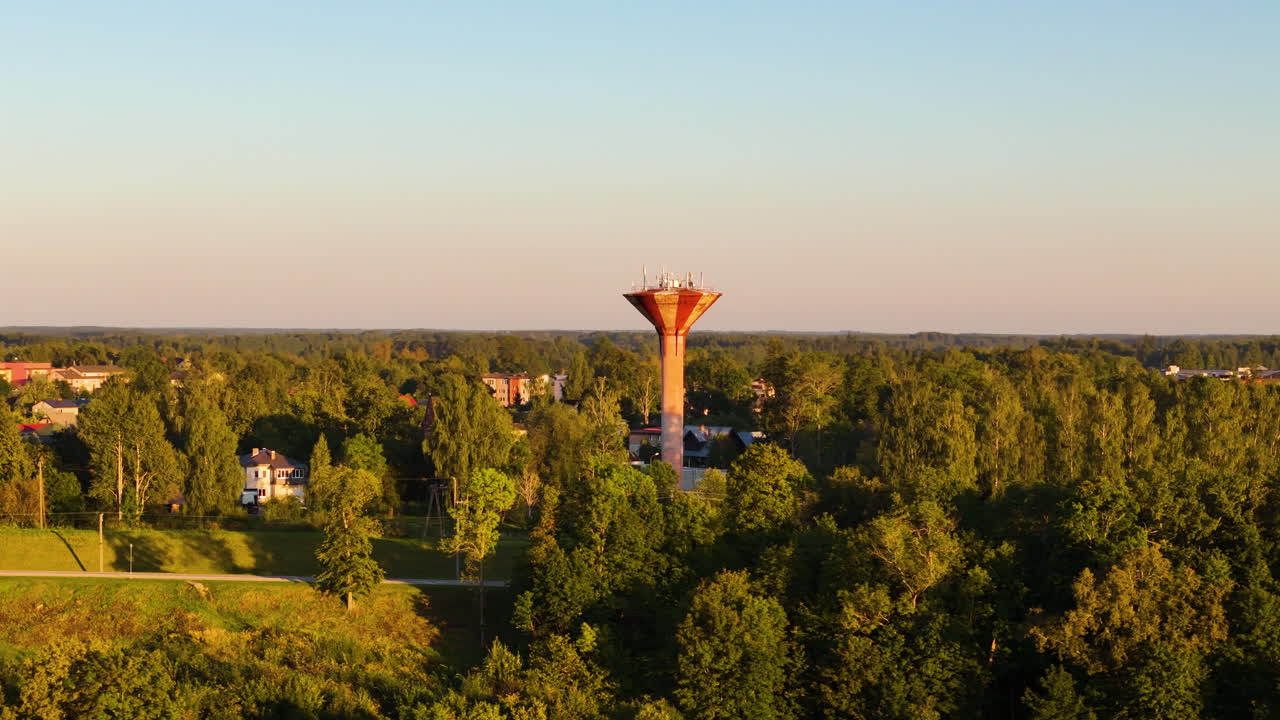 Aerial View of a Water Tower in a Lush Green Landscape