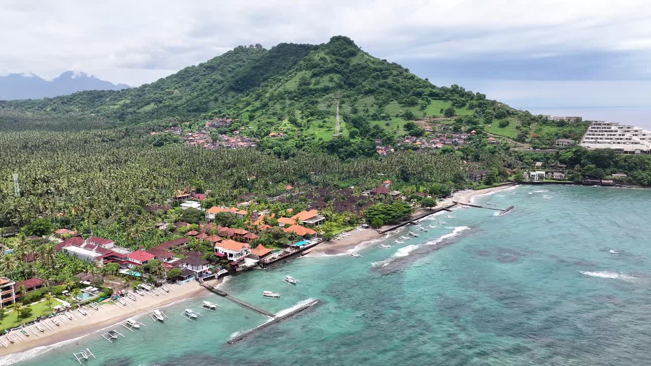 Aerial view of Candidasa Beach and hotels on beachfrot, tropical surroundings. Bali tourism.