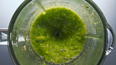 top view blend vegetables swirling inside blender in super slow motion close up.