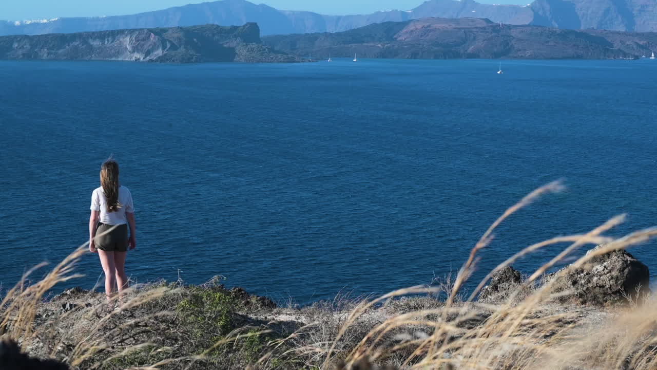 Woman overlooking the Aegean Sea from Santorini