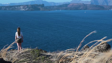 woman overlooking the aegean sea from santorini