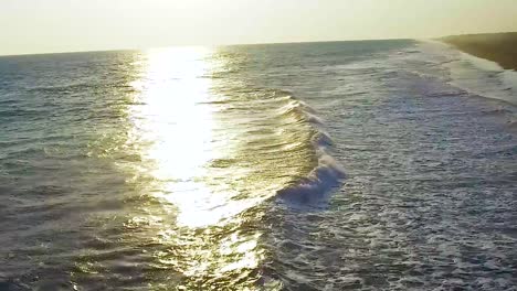 beautiful sunset in the beach with orange, blue and yellow colors.